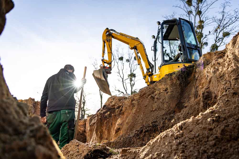 American Rooter technician working on a trench excavation project
