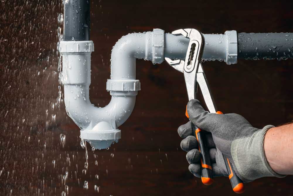 American Rooter technician working on plumbing repairs